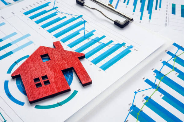 Property investment concept. Home as symbol of real estate and charts.